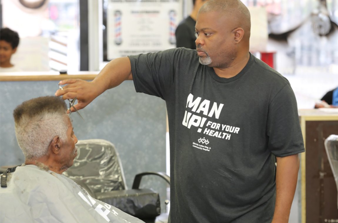 Barber Darryl Jones with a client